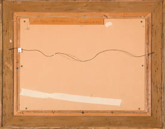 Back of a framed painting: wooden frame, a wire hanger, screws, and a brown cardboard backing with labels taped along the top edge.