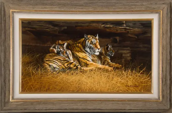 Painting of three Bengal tigers resting in tall grass inside a rocky den, enclosed in a rustic frame.