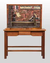 Framed mural on a wooden stand featuring stylized figures, with a bronze standing figure attached to the right side.