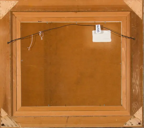 Back of a wooden-framed painting, showing the hanging wire and a white label on the back.