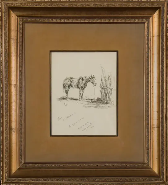 Pencil sketch of a horse standing by a wooden fence, mounted in a brown mat inside a gilded ornate frame.
