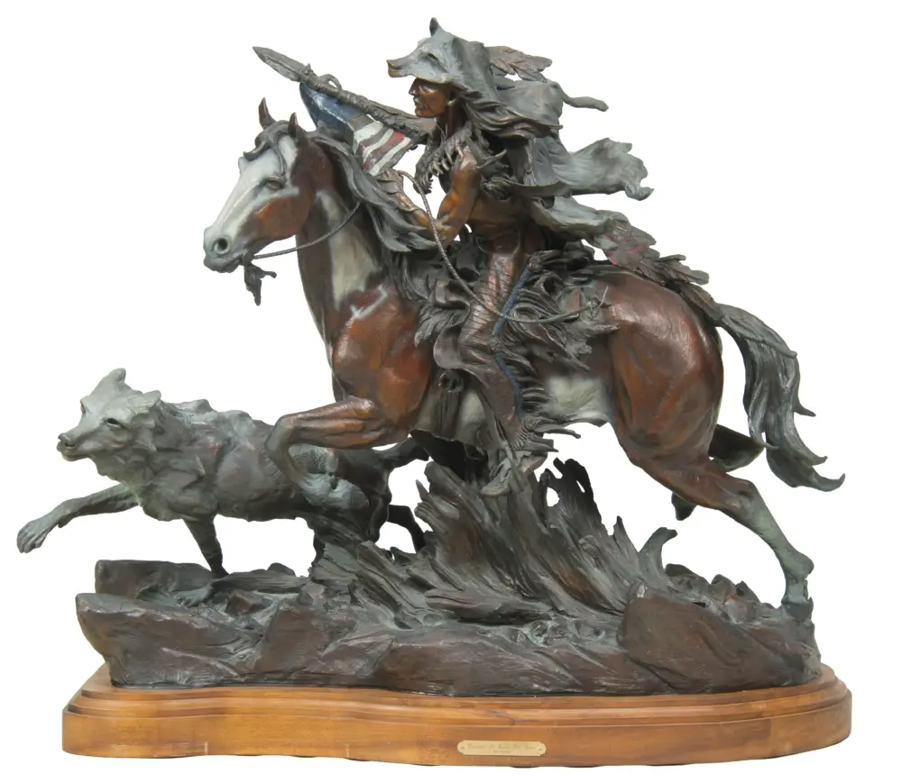 Bronze sculpture of a fearless rider on a rearing horse, rope in hand, with a trailing cape and a galloping dog nearby on a wooden pedestal