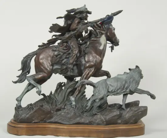 Bronze equestrian statue of a rider on a rearing horse, mounted on a wooden circular base.