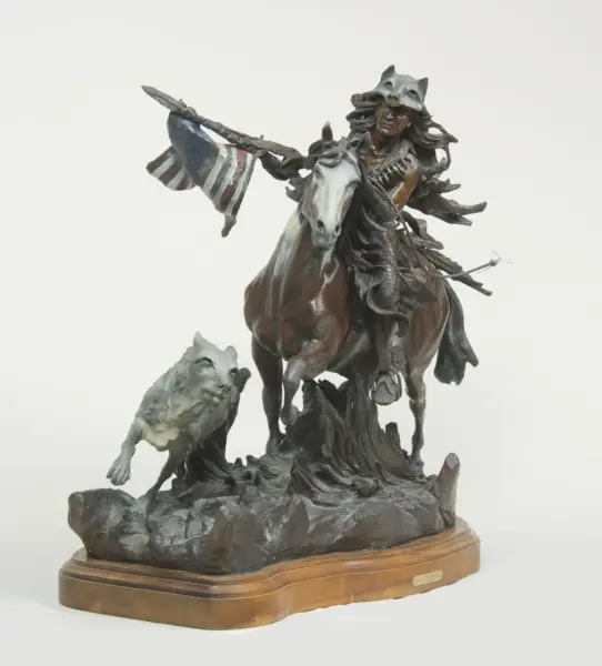 Bronze statue of a warrior on a rearing horse, cloak billowing, set on a wooden pedestal