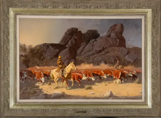 Oil painting of two cowboys on horseback guiding a cattle herd across a rocky desert landscape with large boulders, framed in a decorative gold frame.