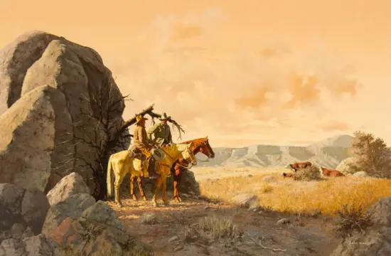Two cowboys on horses beside a rocky outcrop in a arid desert landscape at sunset.