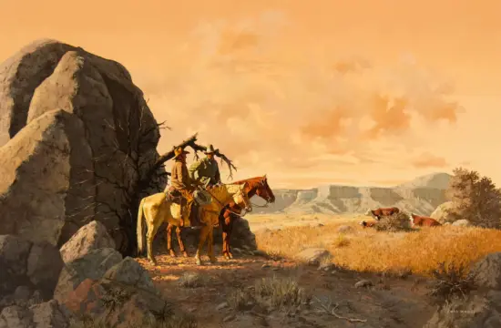 Two cowboys on horseback stand beside a rocky outcrop in a desert at sunset, with cattle grazing in the distance on the plains.