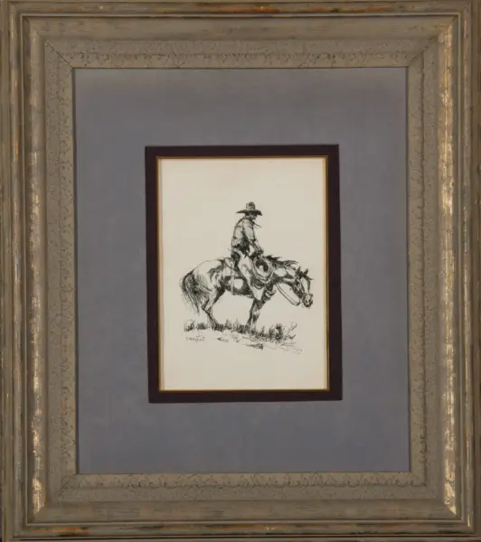Ink drawing of a horseman rider in a simple white mat, framed by a large ornate gray-gold frame.