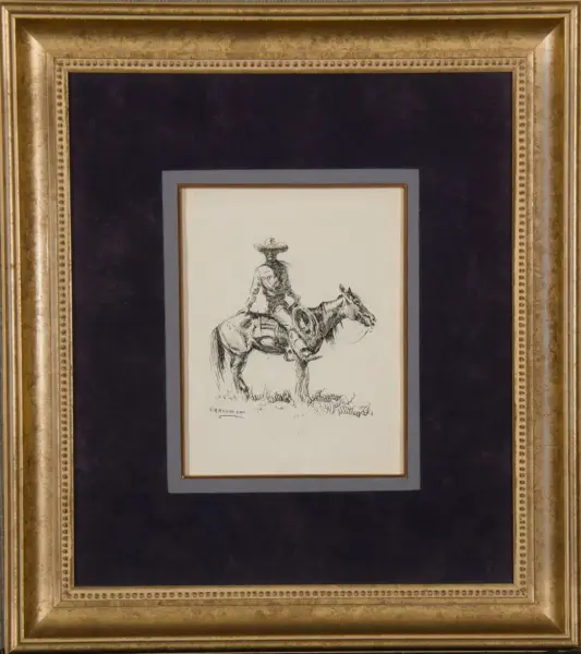 Black-and-white ink sketch of a cowboy in a hat riding a horse, framed within a light mat and ornate gold frame