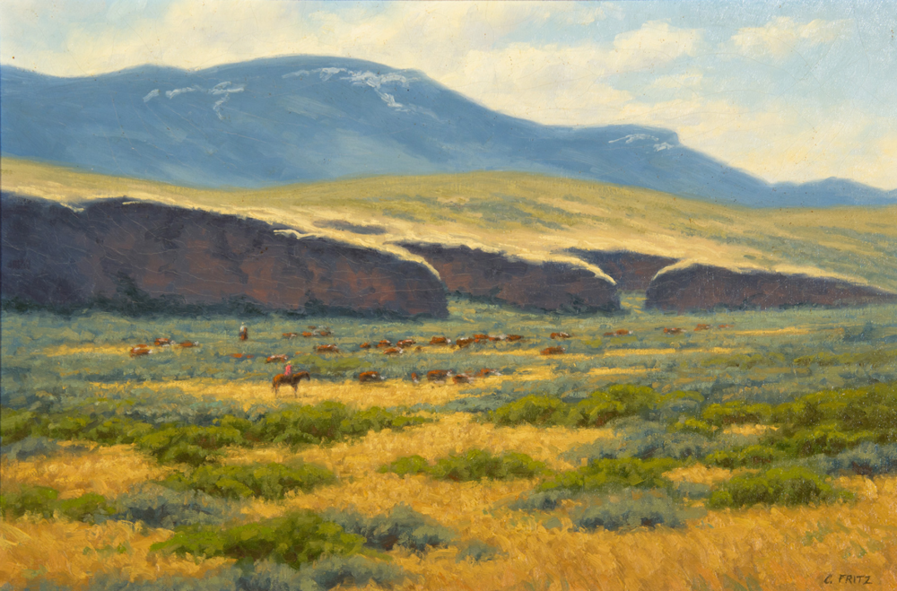 Pastoral landscape with golden fields, a distant herd of cattle, and blue mountains under a pale sky in warm sunlight.