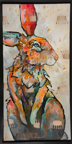 Abstract, colorful rabbit portrait in patchwork style with bold black outlines, framed on a wall.
