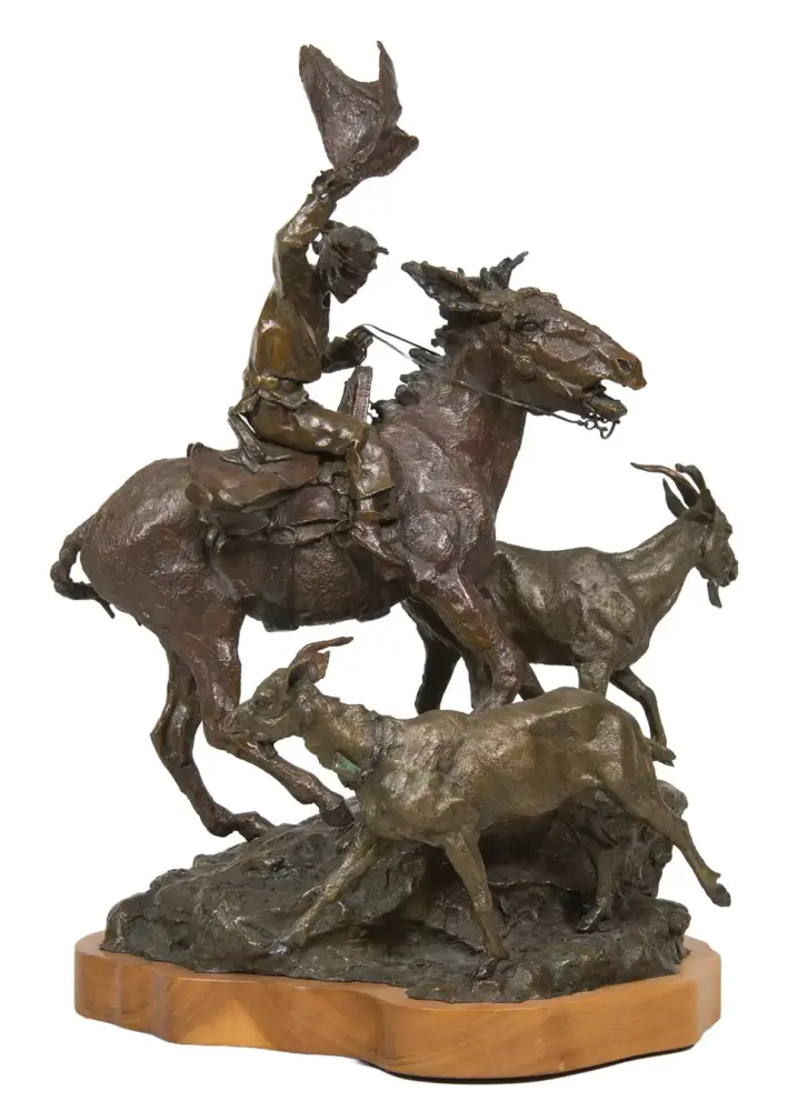 Bronze sculpture showing a rider on a rearing horse wielding a flag, with another horse and figures around on a rocky base on a wooden pedestal.