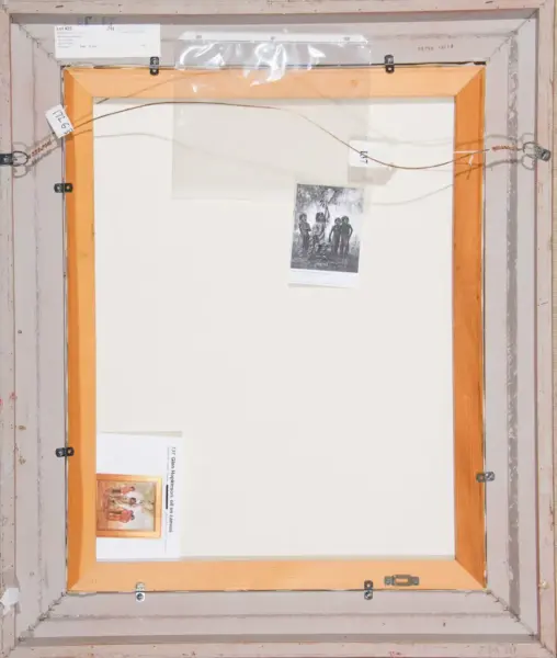 Back of a framed canvas: light wood frame with hanging wire, mounting hardware, and several labels/tags attached to the edges.