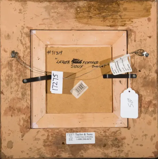 Back of a framed artwork showing a hanging wire, tags, and a Taylor & Sons label on the frame back