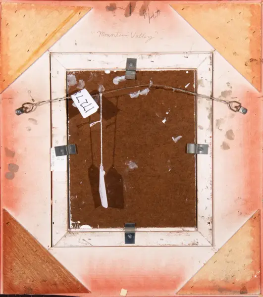 Back of framed painting with orange border, brown backing, and hanging wire; small tags attached.
