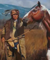 Portrait of a Native American man in a fur hat with a feather, standing beside a brown horse in a mountain landscape; he holds the reins.