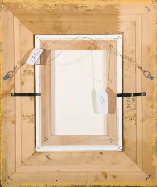 Back view of a framed canvas with hanging wire and two identification tags attached to the frame.