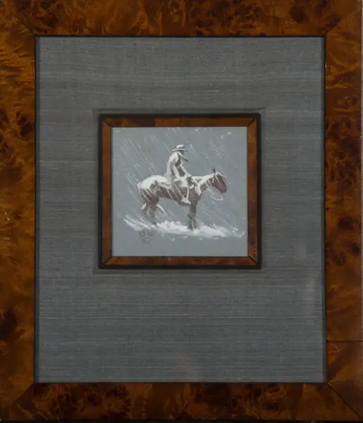 Small square painting of a cowboy on a horse in a snowy scene, framed by brown and gray mats.