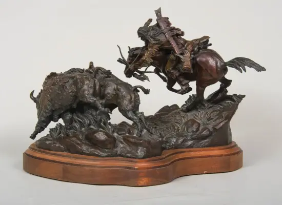 Bronze sculpture showing two bulls and a rearing horse in combat on a rocky base, mounted on a wooden pedestal