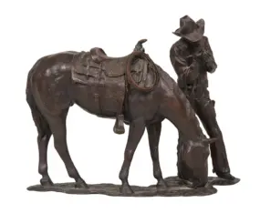 Bronze sculpture of a cowboy kneeling beside a saddled horse, with a rope hanging from the saddle.