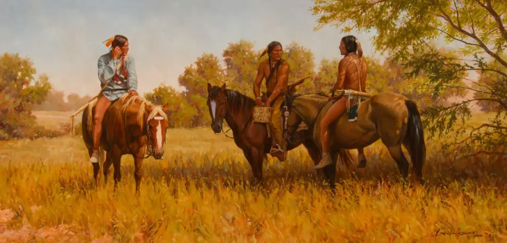 Four Indigenous men on horses in a sunlit autumn field, chatting as trees glow in the background."