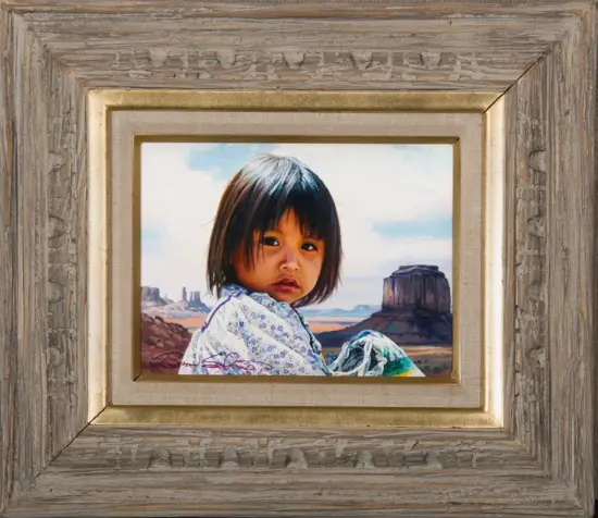Portrait of a young girl with dark hair in a patterned dress, with a desert landscape and buttes in the background, framed artwork.