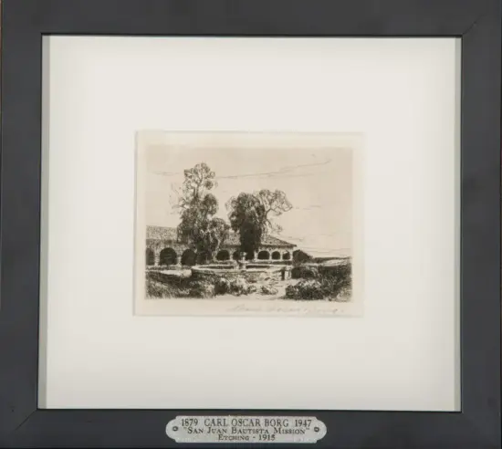 Framed black-and-white etching of San Juan Bautista Mission with arched colonnade and trees; plaque notes Carl Oscar Borg (1879–1947).
