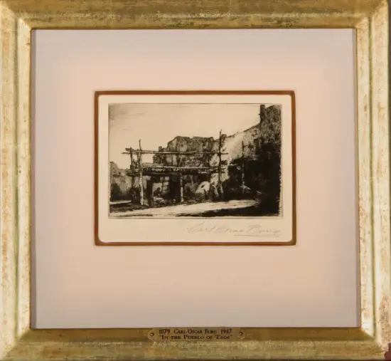 Monochrome etching of a Taos Pueblo ruin with wooden scaffold, framed and matted; plaque cites artist Carl Oscar Borg and the title 'In the Pueblo of Taos'.