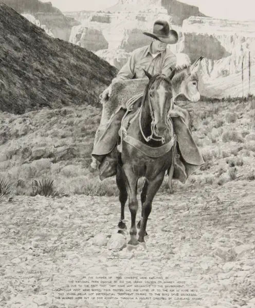 Cowboy rides a horse along a rocky trail in a desert canyon with a donkey resting in the background.