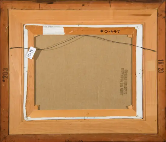 Back of a stretched canvas in a wooden frame with a hanging wire and shipping labels attached to the frame, viewed from the rear.