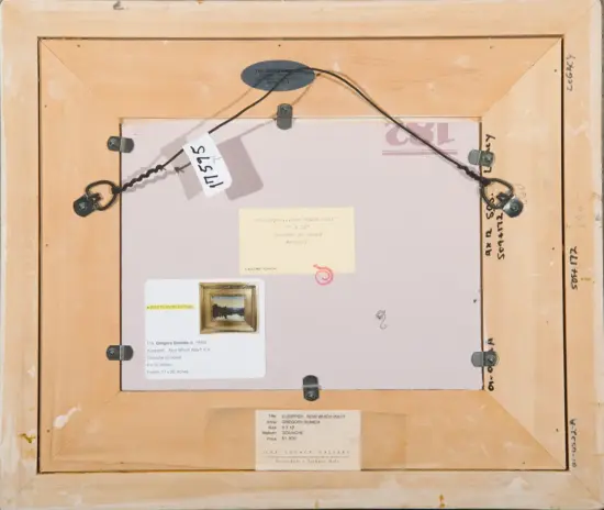 Back of a wooden frame with a wire hanger, metal hardware, and several labels and tags attached to the back of a framed artwork.