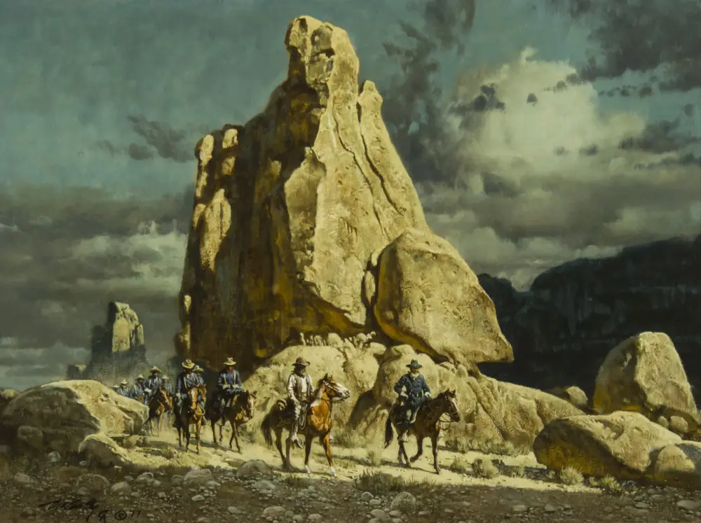 Mounted soldiers ride along a rocky hillside beneath a tall jagged rock formation and dramatic sky