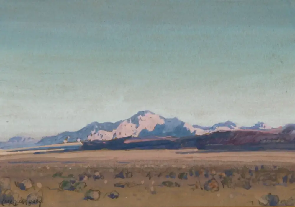 Pastel-toned landscape painting of distant snow-capped mountains under a pale blue sky with a flat, rocky foreground.