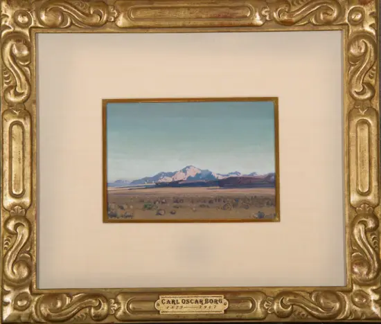 Ornate gold frame surrounds a small landscape painting of mountains under a pale blue sky, signed Carl Oscar Borg (1879–1947).