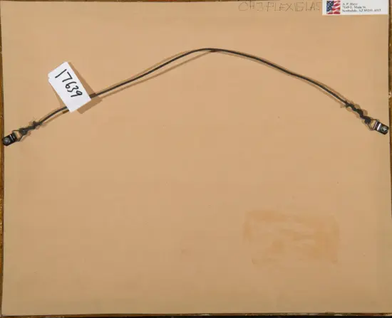 Two-end electrical lead with metal clips connected by a black wire, laid across a brown backing with a white tag reading 1769.