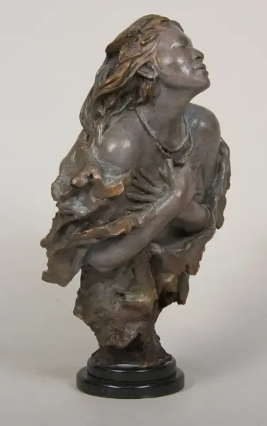 Bronze sculpture of a woman with flowing hair, hands crossed over her chest, head tilted upward on a black pedestal.