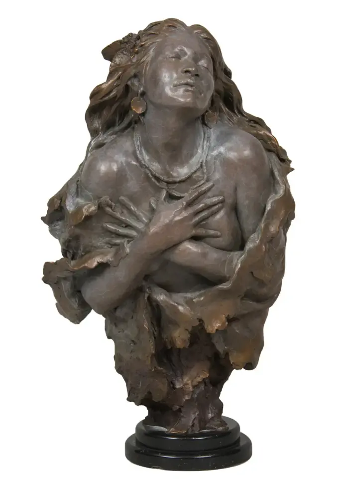 Bronze sculpture of a woman with eyes closed, hands crossed over her chest, flowing hair, mounted on a black pedestal base.