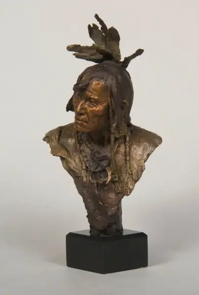 Bronze-textured bust sculpture of a person with jagged, branch-like headpiece on a black pedestal.