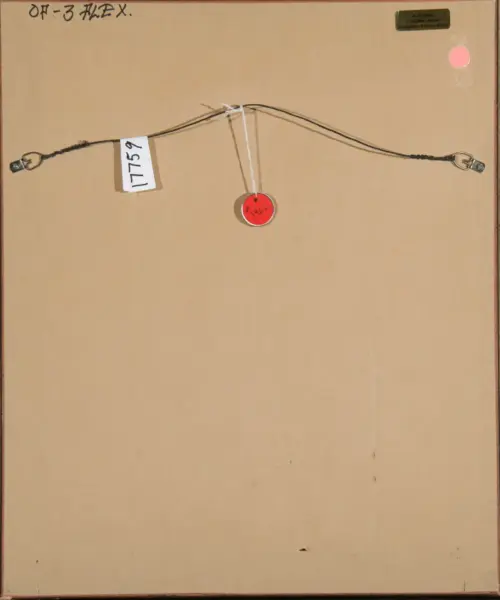 Back of a framed artwork showing a hanging wire across the top, metal end hooks, a white tag with numbers, and a red circular label in the center edge of the frame.