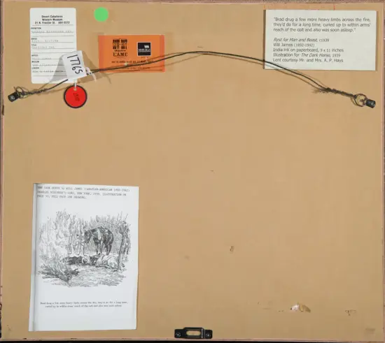 Back of a framed piece with labels, a hanging wire, and a small orange tag; bottom left shows a printed illustration page.