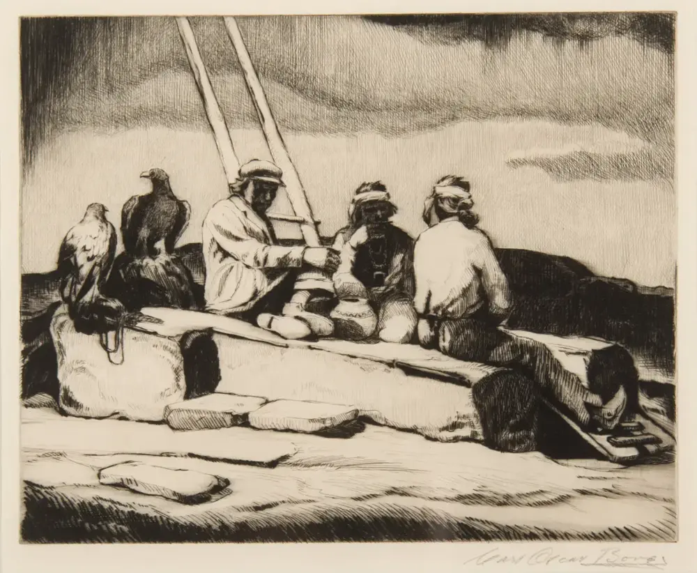 People sit on a boat at the shore, with two birds perched nearby and a tall mast behind them.
