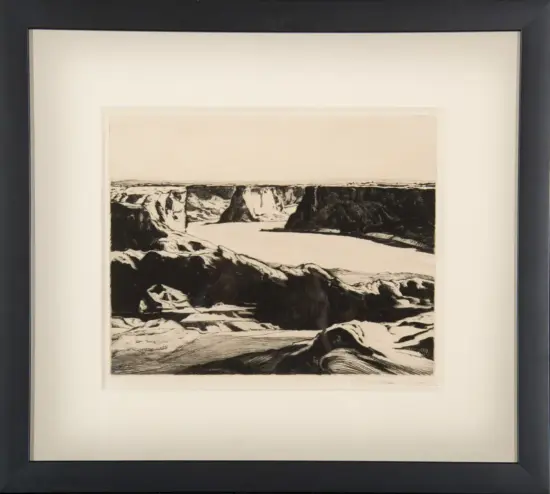 Framed black-and-white landscape print of a rocky canyon with a winding river.
