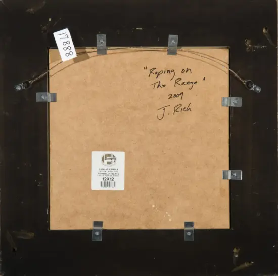 Back of a framed artwork showing hanging wire, corner brackets, and a handwritten title: “Roping on The Range” (2007) J. Rich. 12x12 canvas label nearby.