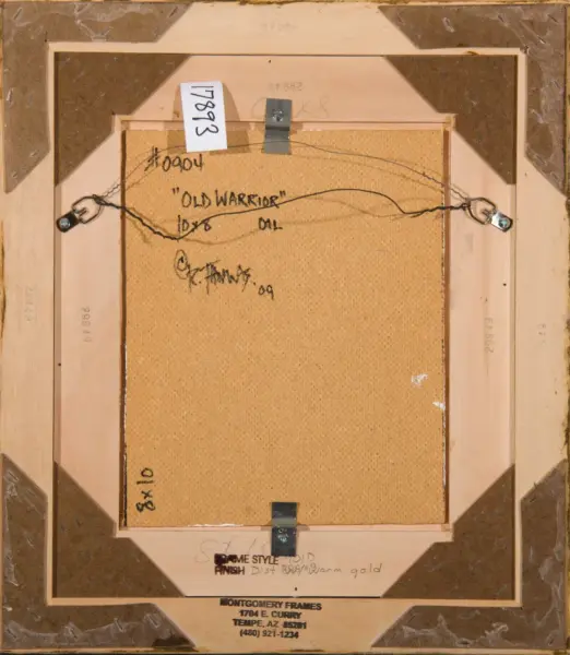 Back of a framed painting with hanging wire, corner brackets, and a cardboard backing; frame labeled by Montgomery Frames.