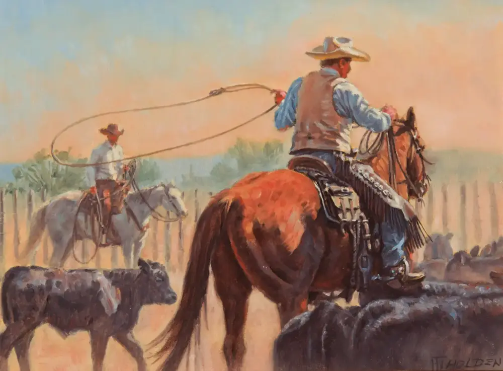 Two cowboys on horseback crossing rocky ground at sunset, one swinging a lasso while another watches nearby.
