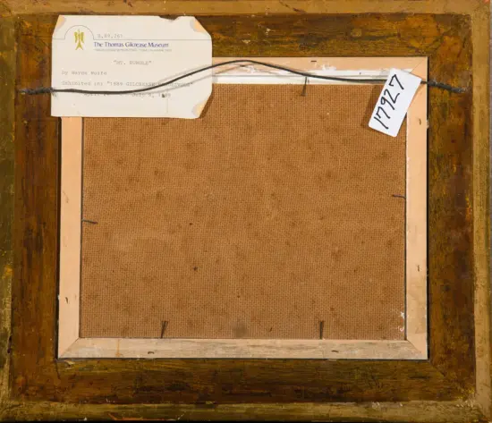 Back of a framed painting on a wooden frame with a hanging wire and a museum label reading 'Mt. Rundle' by Wayne Wolfe, including exhibition details from The Thomas Gilcrease Museum.