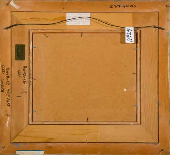 Back of a framed canvas with hanging wire and labels, showing a wood frame and beige canvas surface.