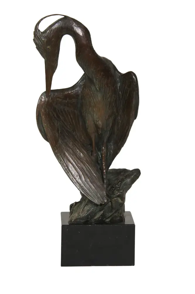 Bronze sculpture of a tall, long-necked bird (likely a heron) standing on a black pedestal with its neck curved downward.