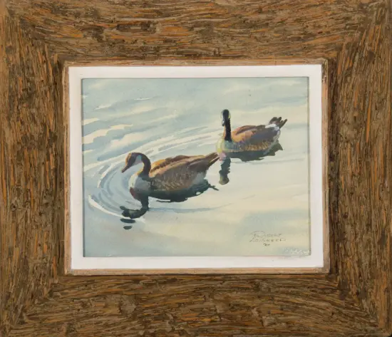 Watercolor painting of two ducks swimming on a light blue pond, framed in a rough wooden frame.