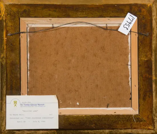 Back of a framed canvas with brown burlap, hanging wire, and a museum label in the lower-left corner.